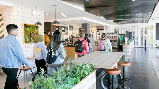 Students walking through a cafe area